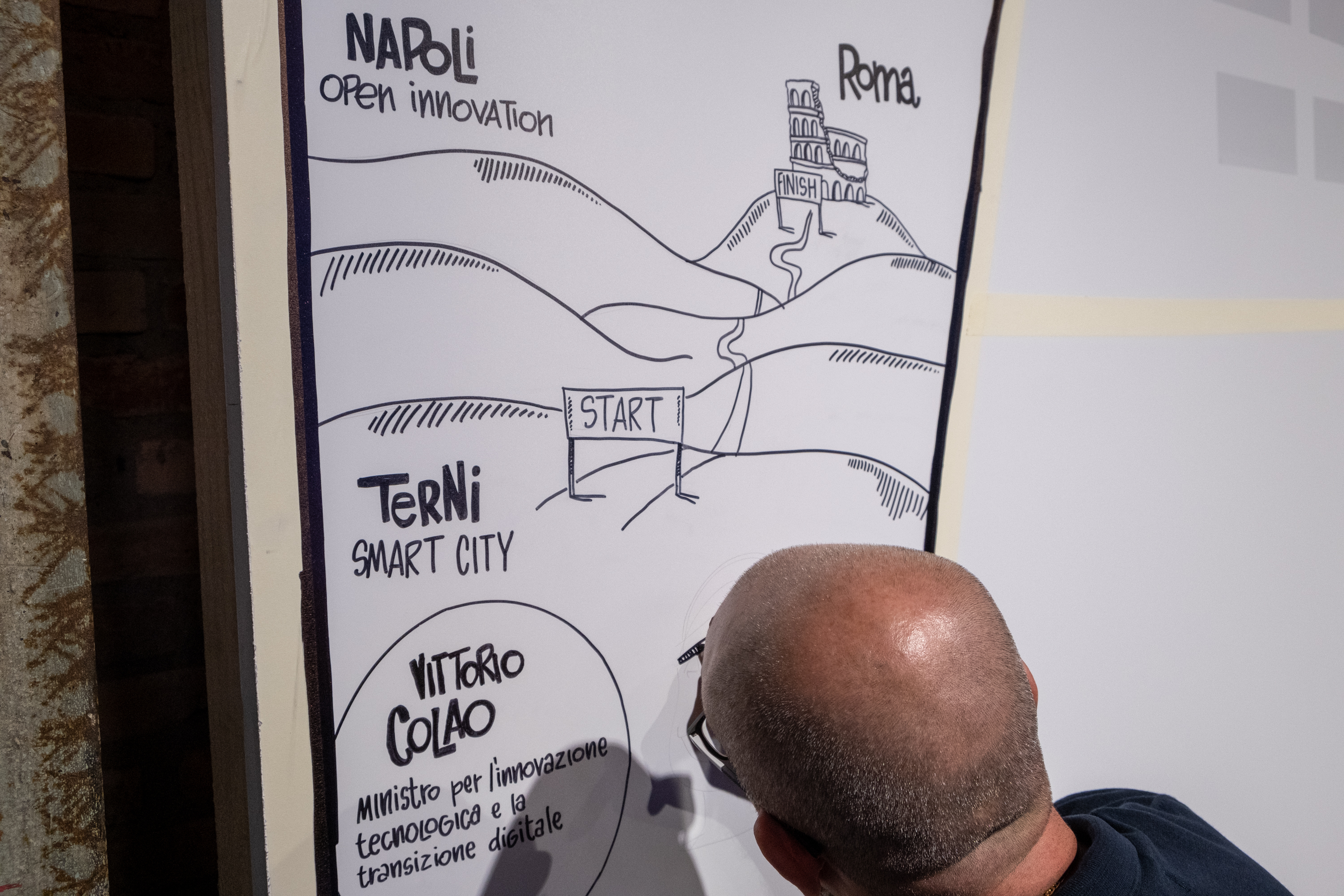 photo of a participant of the final stage of the Acea Innovation Tour in Rome drawing on a canvas