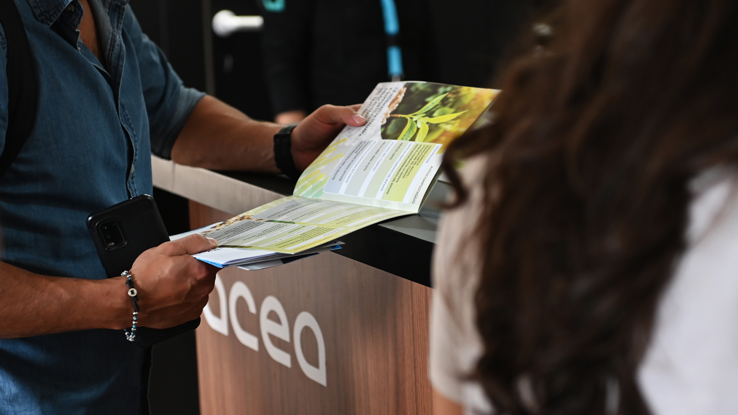 Una persona sfoglia un depliant di Acea