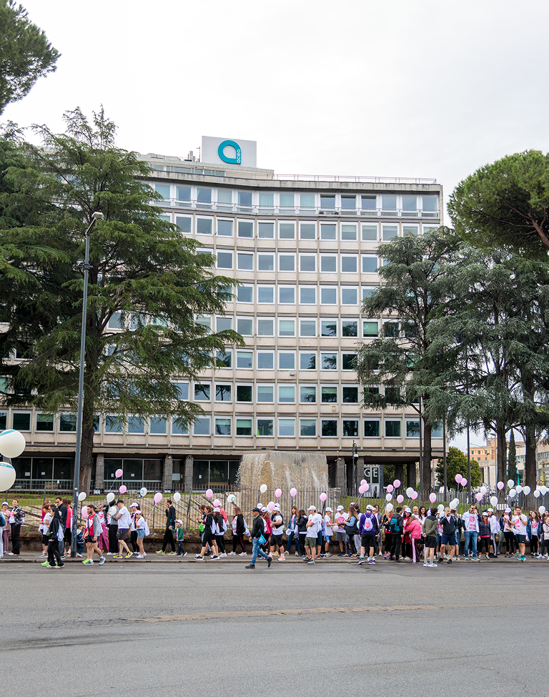 Participants in the Race for the Cure event on May 10, 2026, with the Acea headquarters in the background