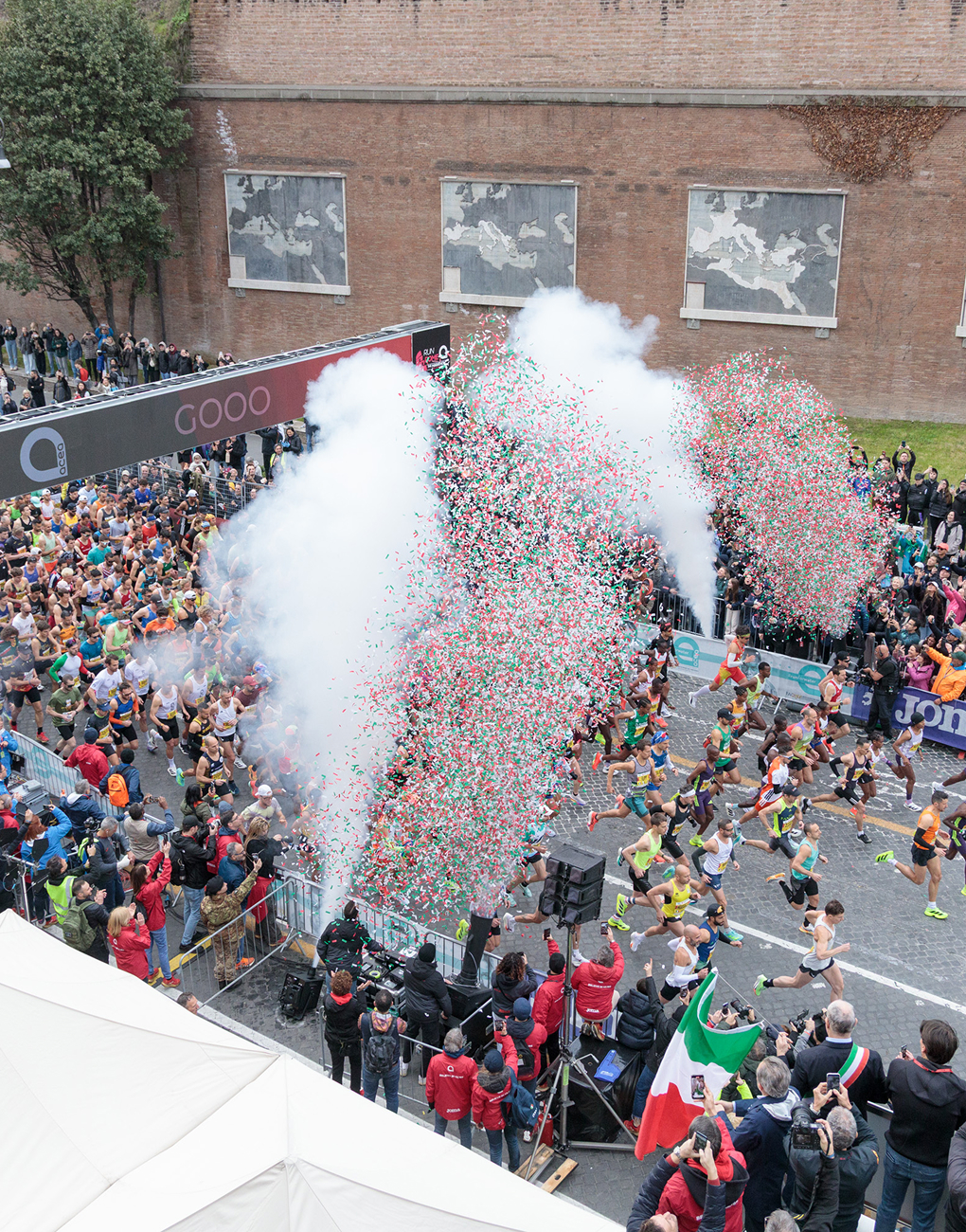 view of the starting line of the 2026 Acea Run Rome Marathon, with puffs of steam and colorful confetti