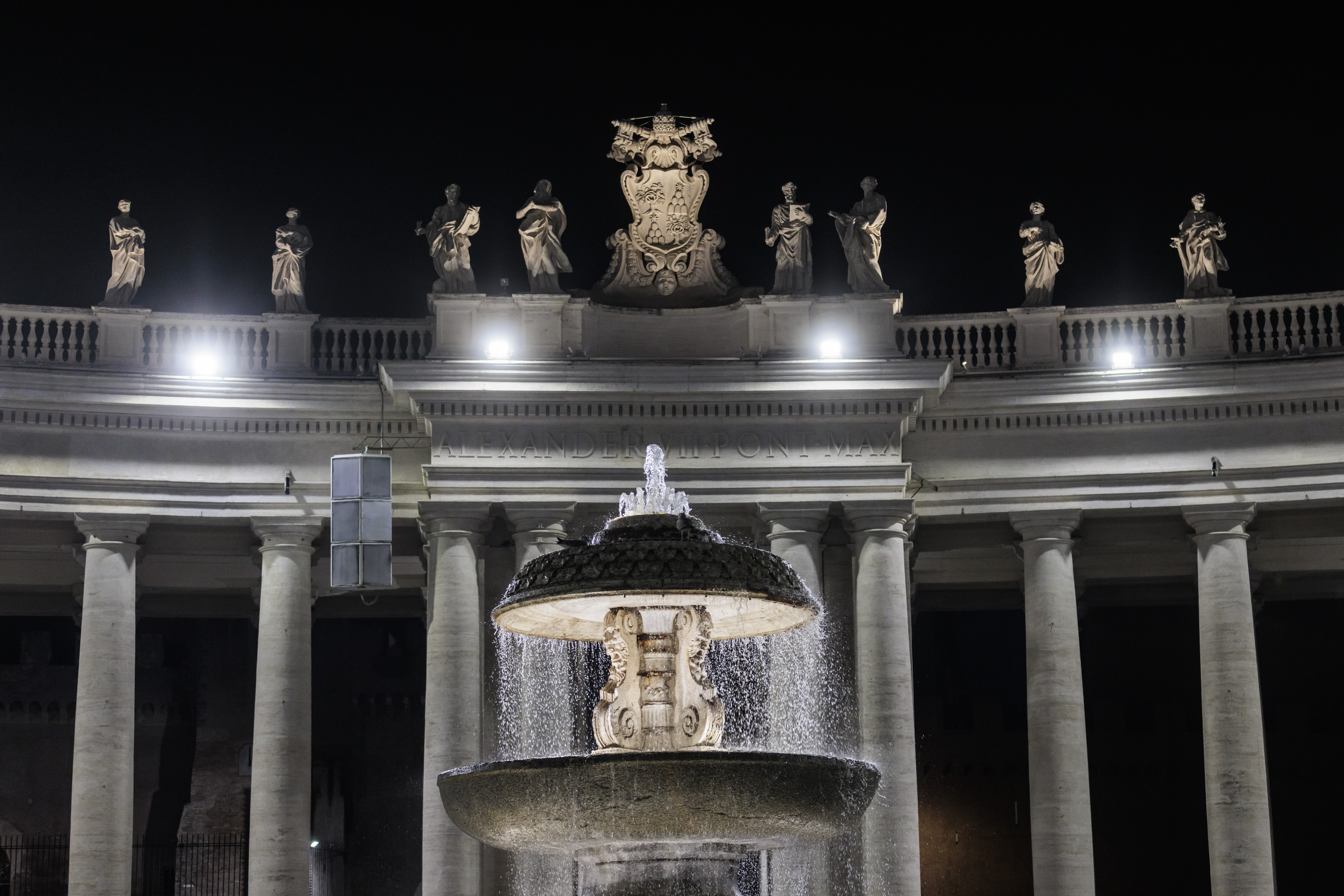 Fontana e statue del colonnato di Piazza San Pietro illuminati