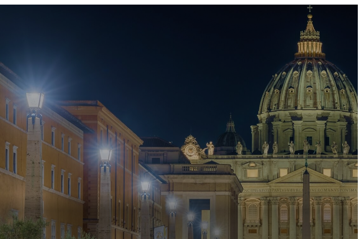 Lampadari di via della Conciliazione illuminati, con dietro la Basilica di San Pietro