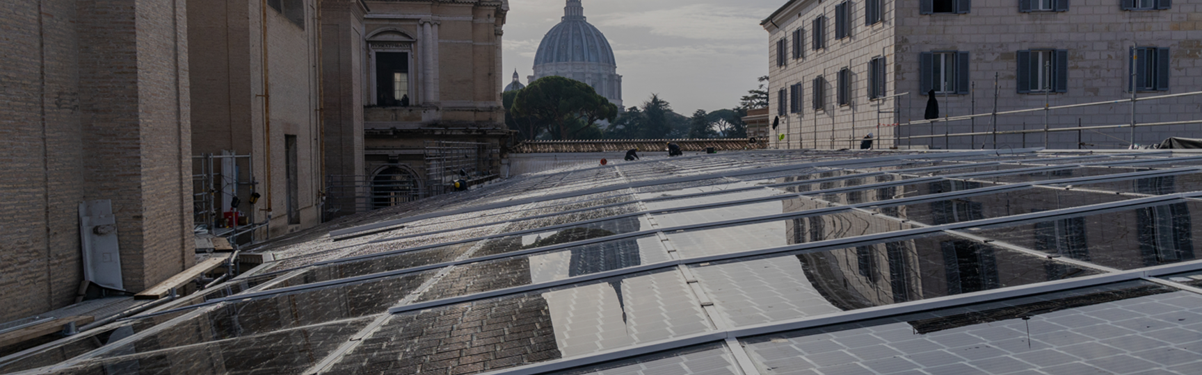 photovoltaic panels can be seen in the foreground and the Vatican in the background